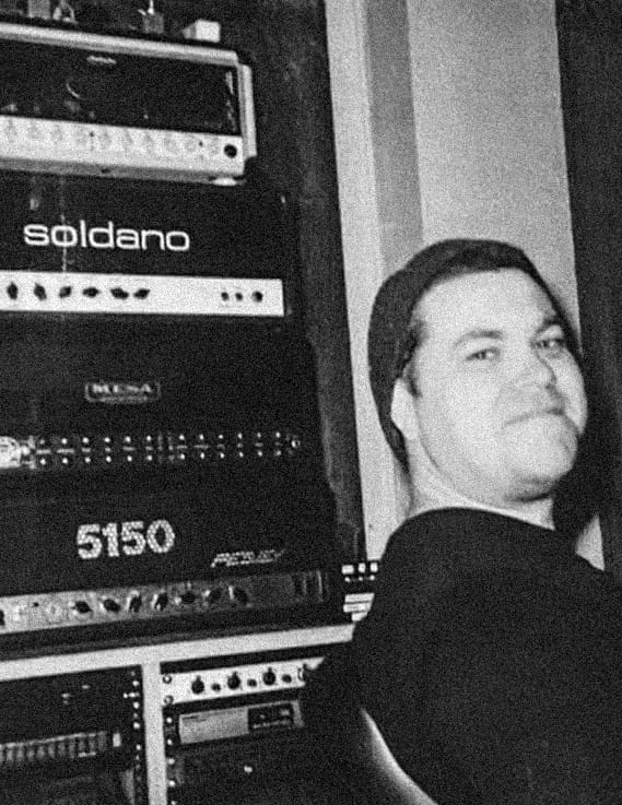 Jack Hartley seated beside a rack of studio gear